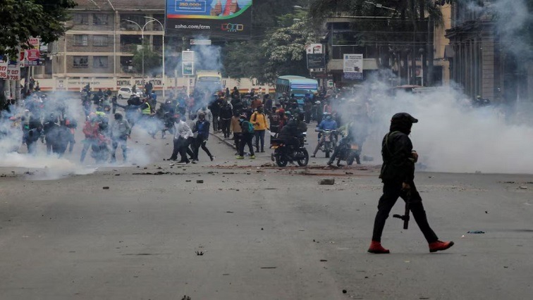 A police officer walks after using tear gas to disperse protesters during a demonstration over police killings of people protesting against Kenya's proposed finance bill 2024/2025, in Nairobi, Kenya, June 27, 2024.