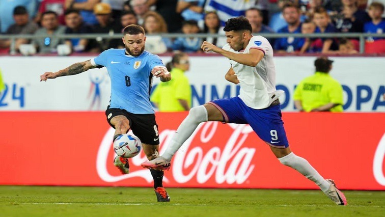 Jul 1, 2024; Kansas City, Missouri, USA; United States forward Ricardo Pepi (9) and Uruguay midfielder Nahitan Nandez (8) fight for the ball during the first half of a Copa America match at Arrowhead Stadium.
