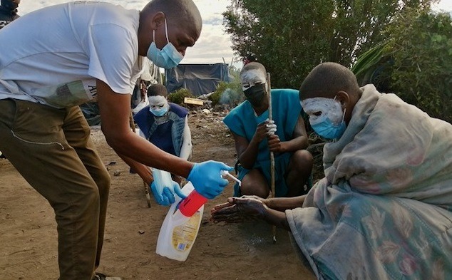 Initiates sanitising their hands